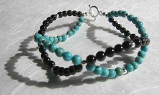 Handcrafted turquoise and black onyx bracelet with sterling silver toggle clasp.